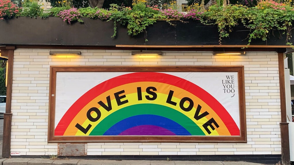 A mural of a rainbow with the words Love Is Love